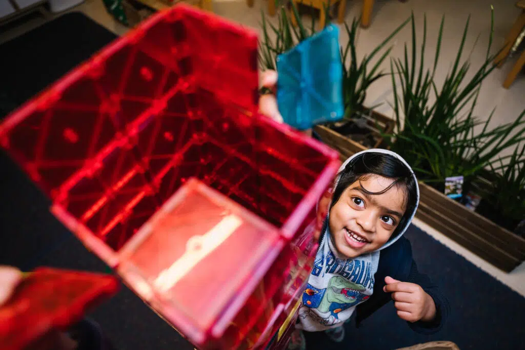 Child building a tower at KU Liverpool childcare