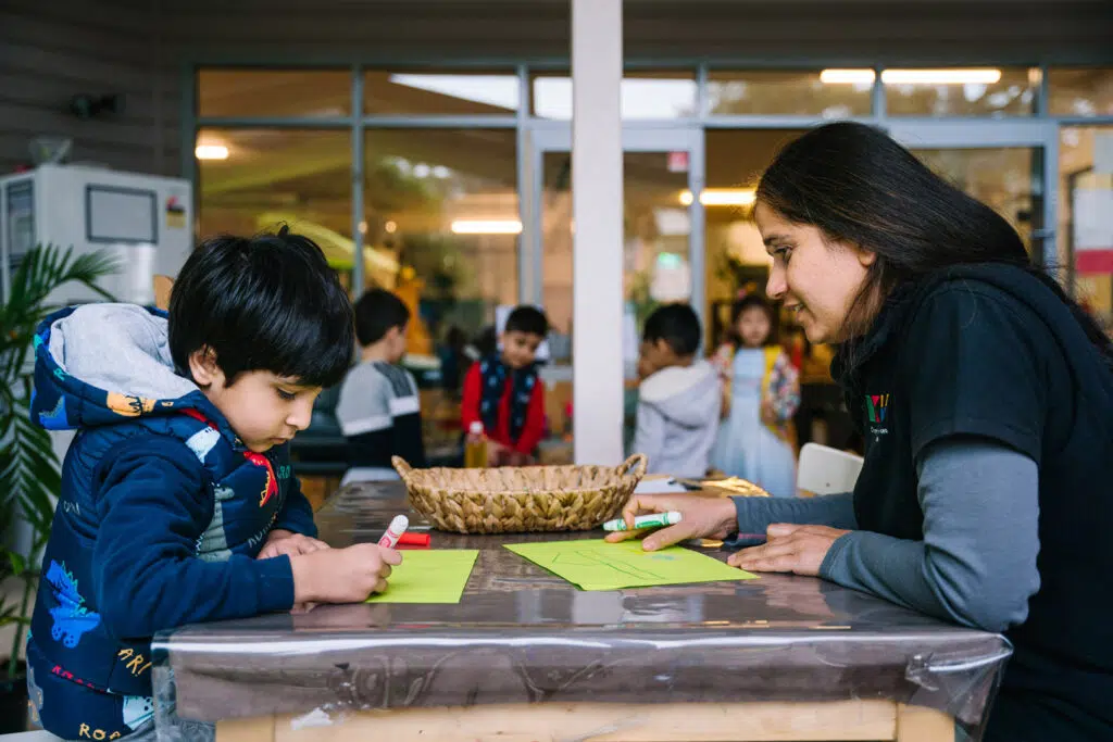 KU Liverpool childcare educator and a child drawing pictures
