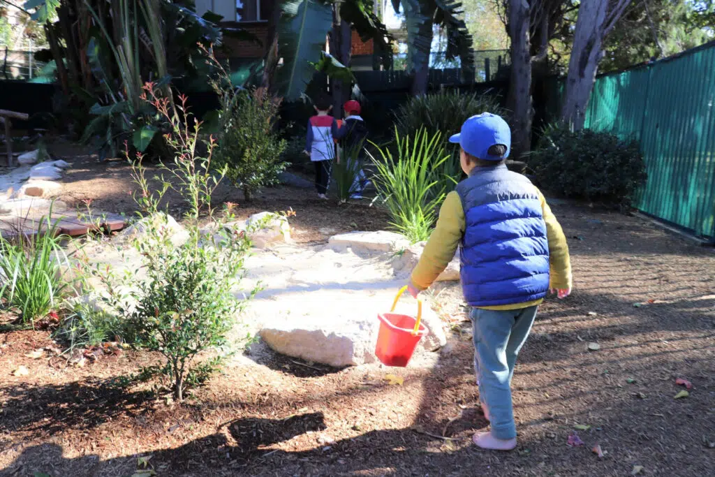 Child playing outdoors at KU Crusader childcare