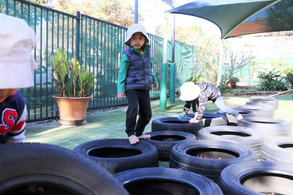 Children playing outdoors at KU Crusader childcare