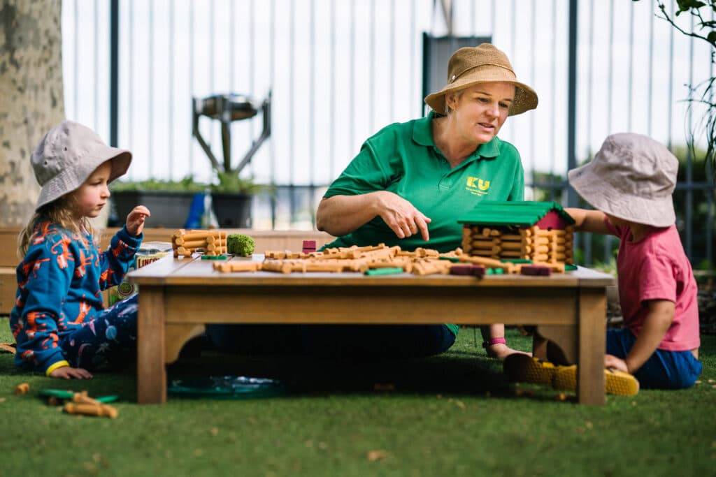 KU Lance childcare educator building mini farm sets with children