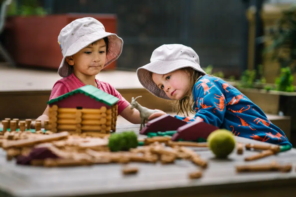 Children playing with a mini farm set at KU Lance childcare