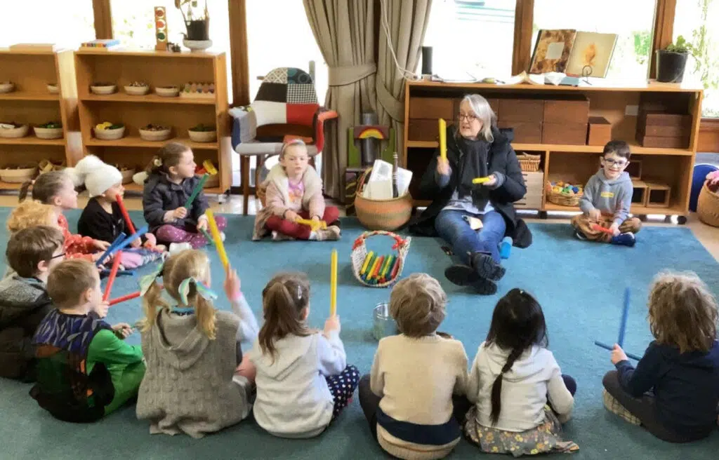KU Donkin childcare educator and children sitting in a circle