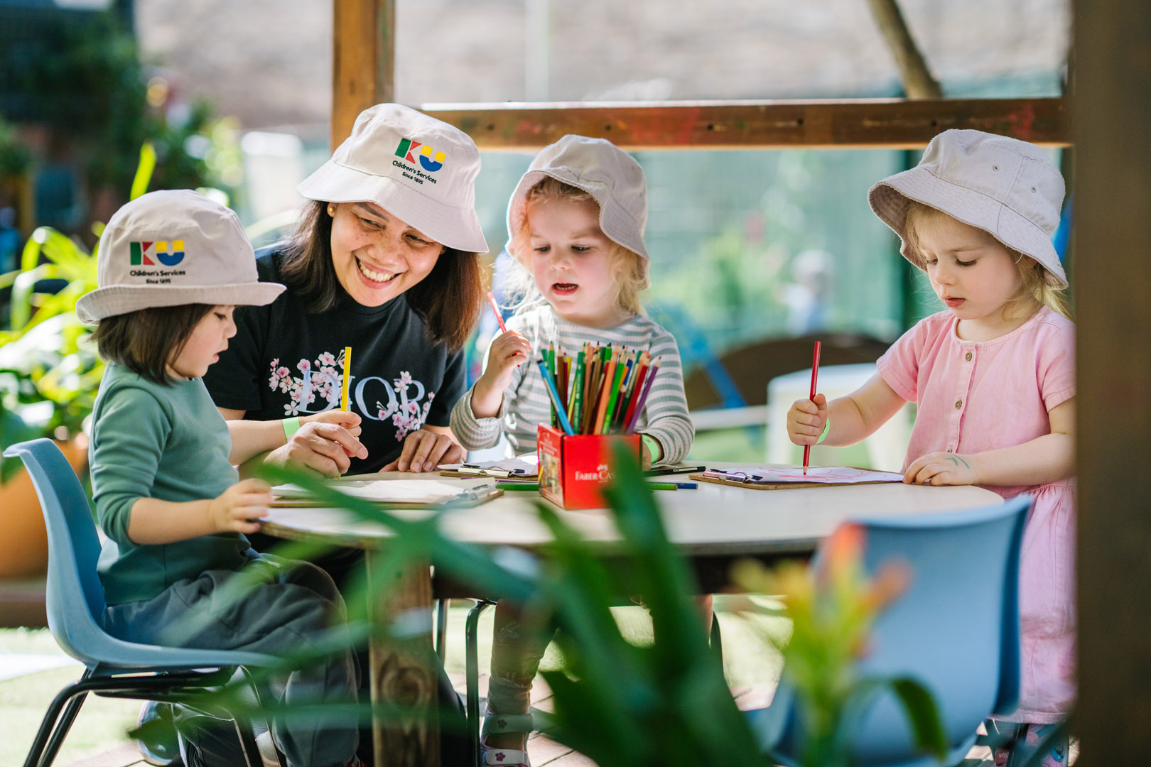 Children and educator drawing at Newtown childcare Carillon Avenue Children's Centre