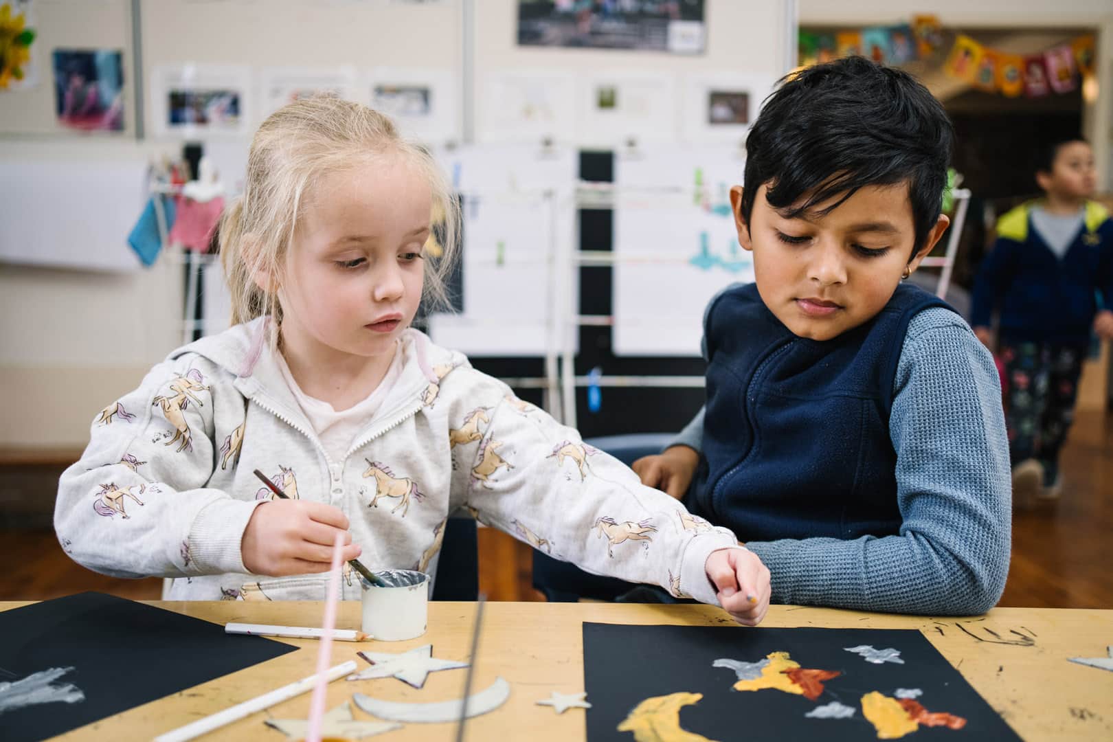 Children doing a painting at KU Greenwood childcare
