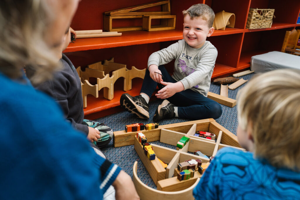 Children playing with wooden blocks at KU Greenwood childcare