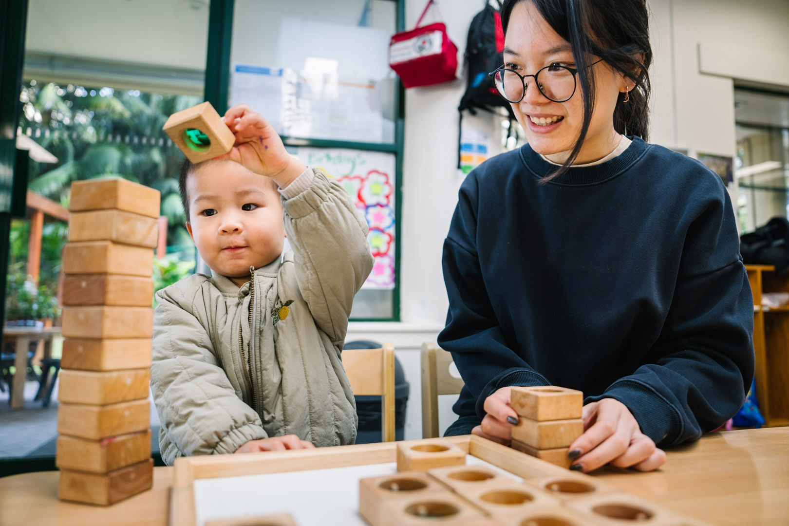 Educator and child engaged in block play at North Sydney Childcare