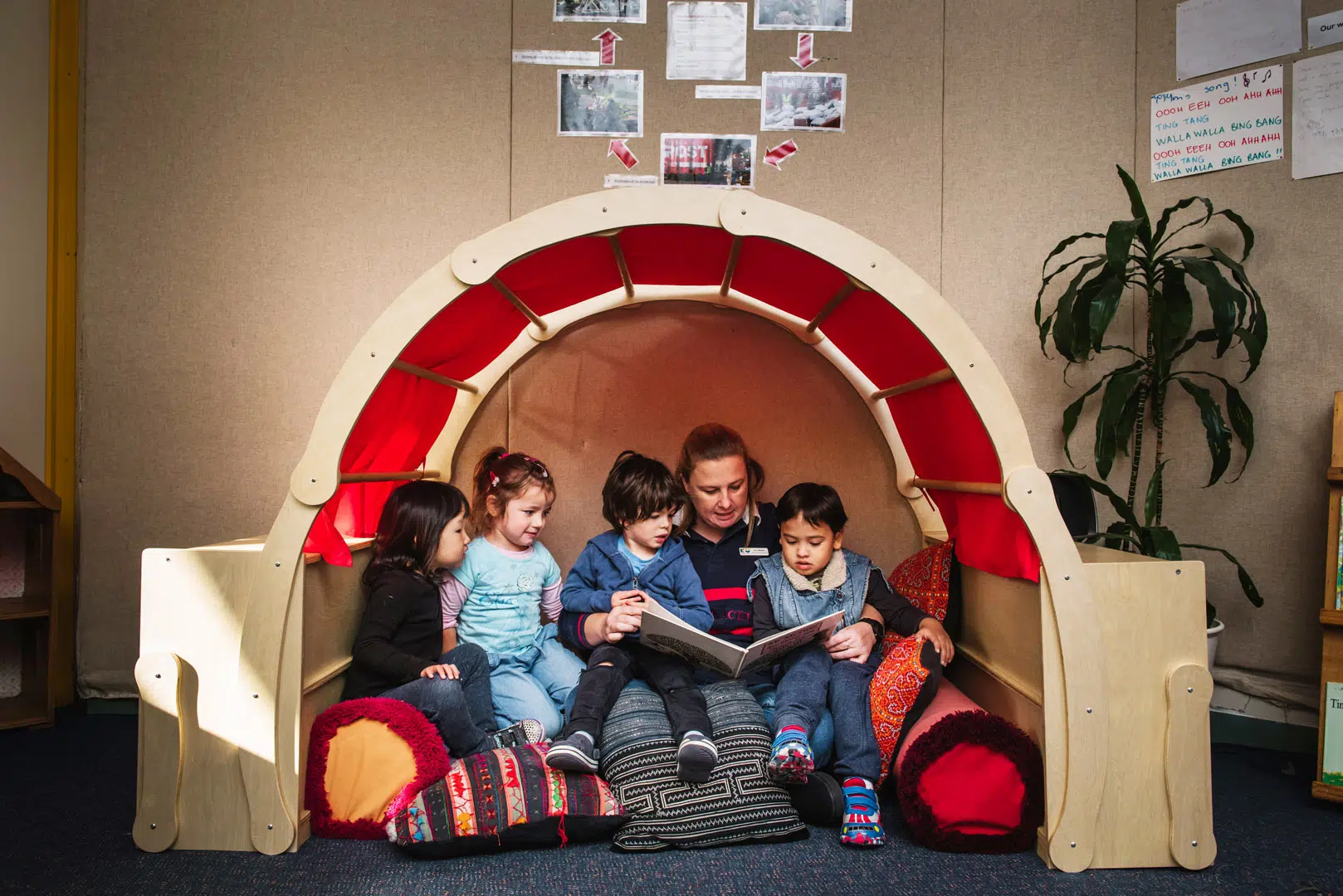 KU Grandstand childcare educator reading a story to children