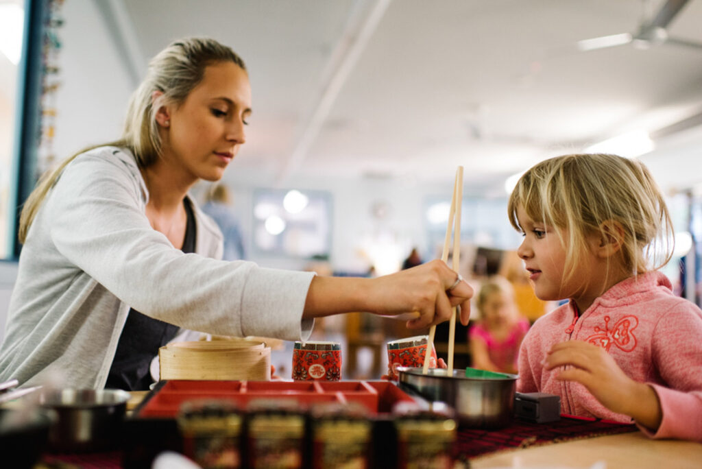 KU Ourimbah childcare educator and a child doing a painting