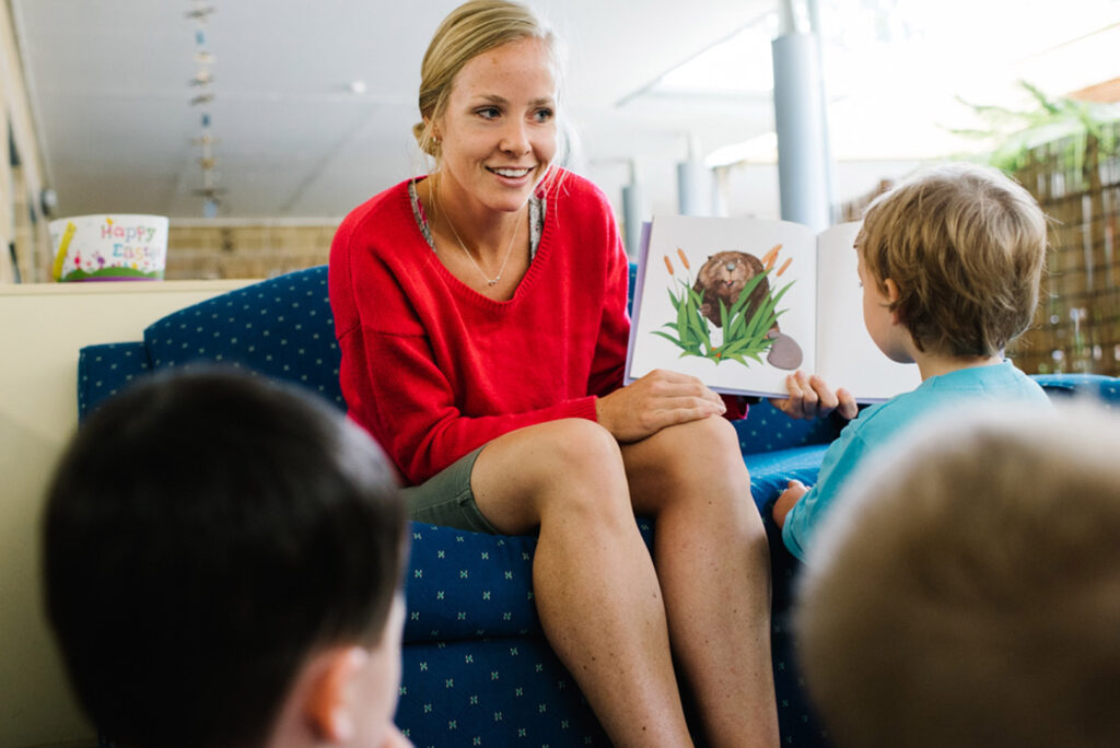 KU Ourimbah childcare educator reading a story to children