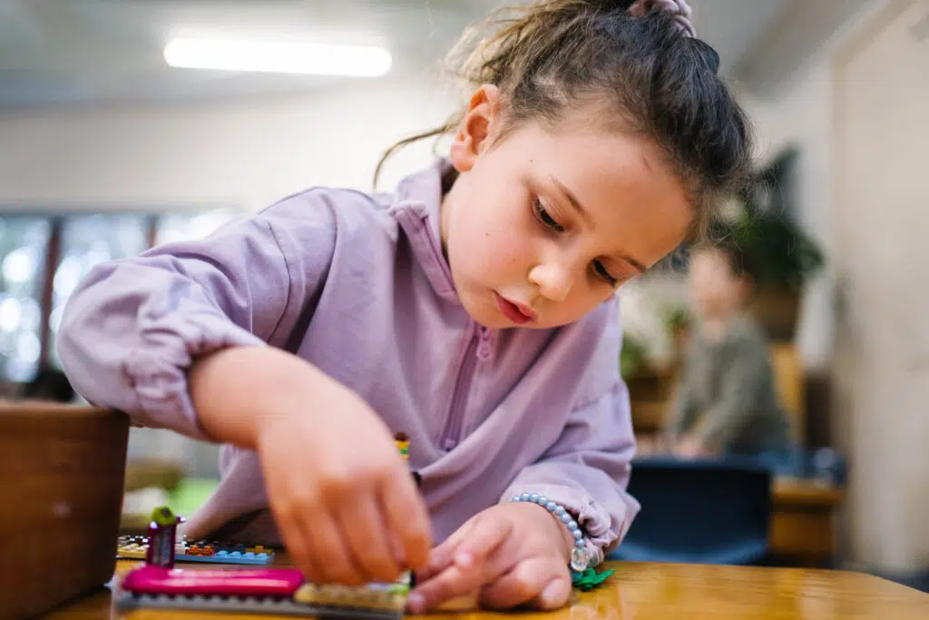 Child building with Lego at Kira childcare