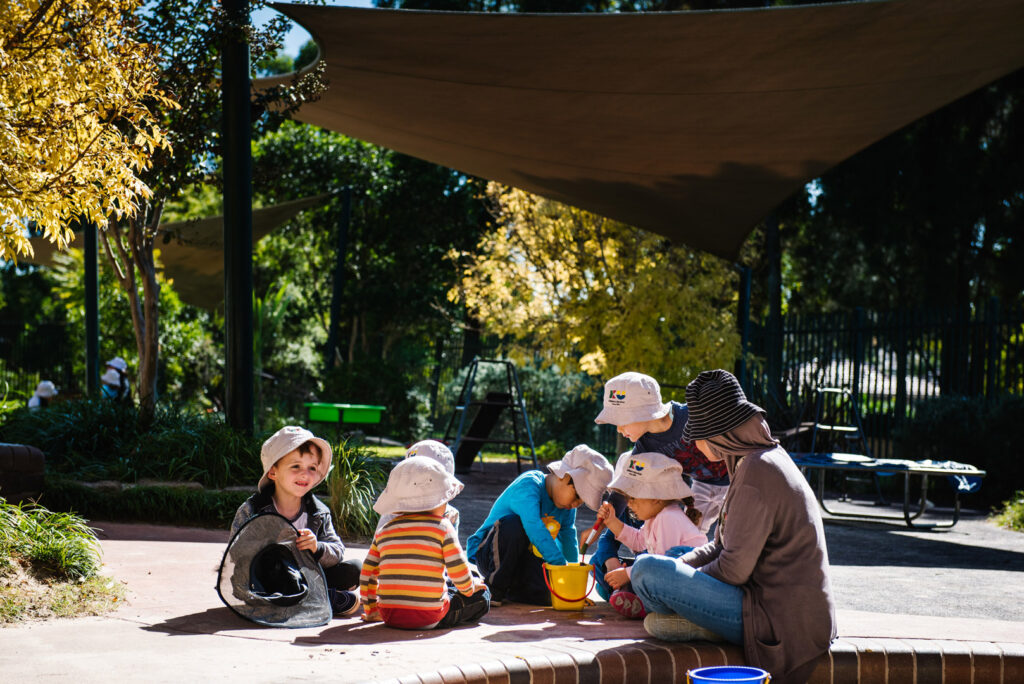 KU Playford Park childcare educator and children sitting in a circle