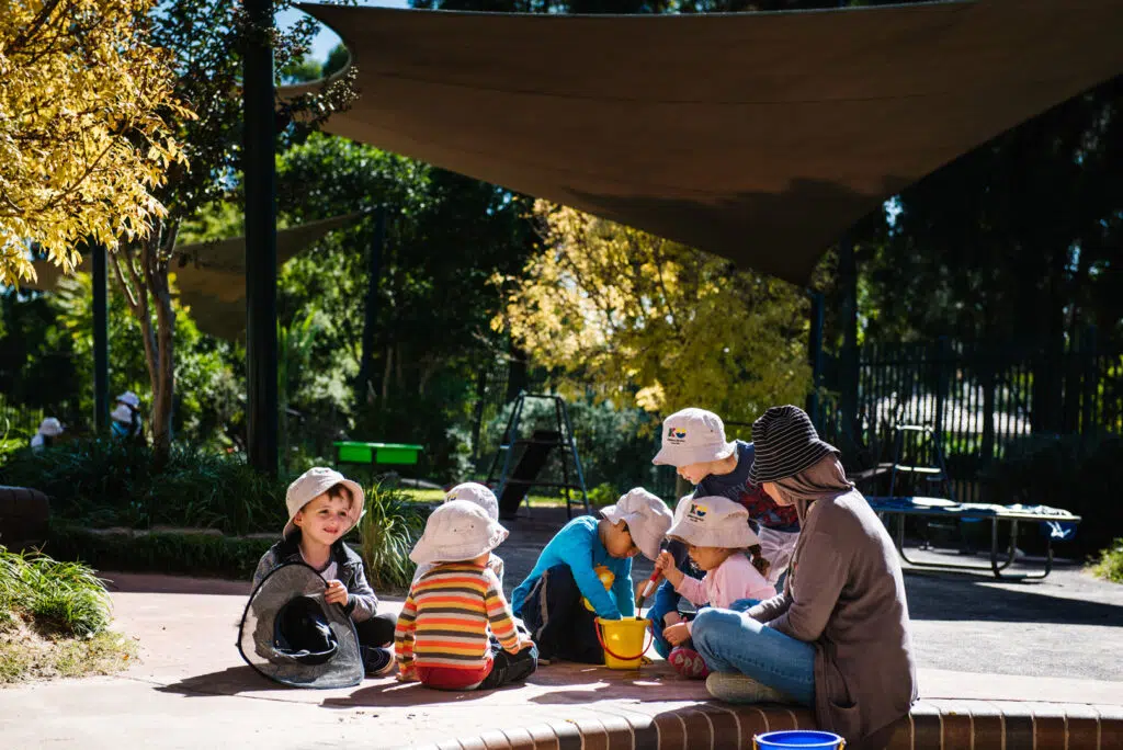 KU Playford Park childcare educator and children sitting in a circle