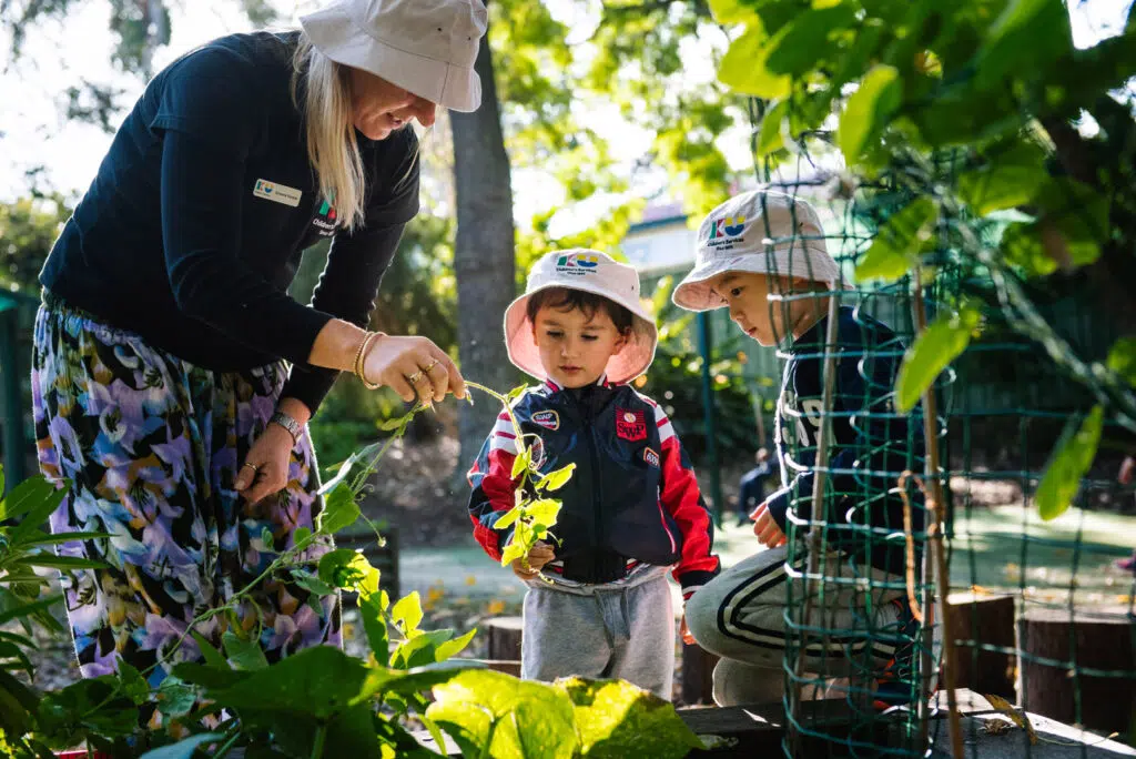 KU Padstow childcare educator and children in the garden