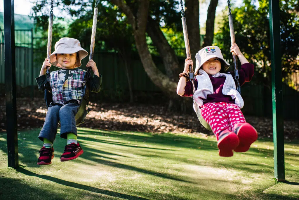 Children on the swings at KU Padstow childcare