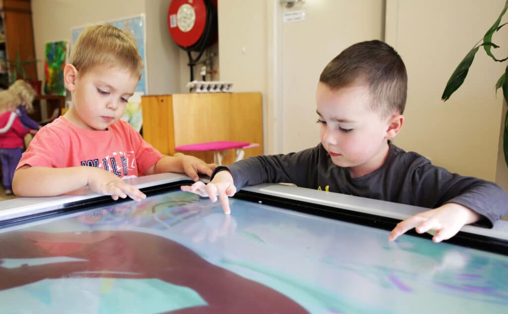 Children using an interacting learning table at KU Queanbeyan childcare