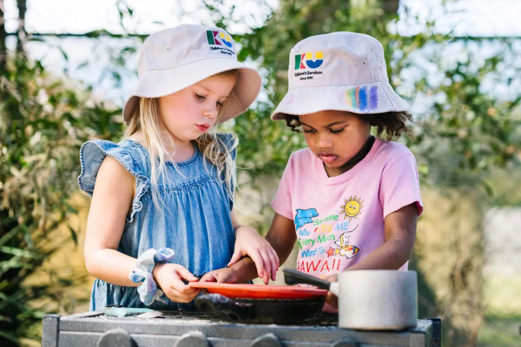 Children playing together outdoors at KU The Fields childcare in Rowville