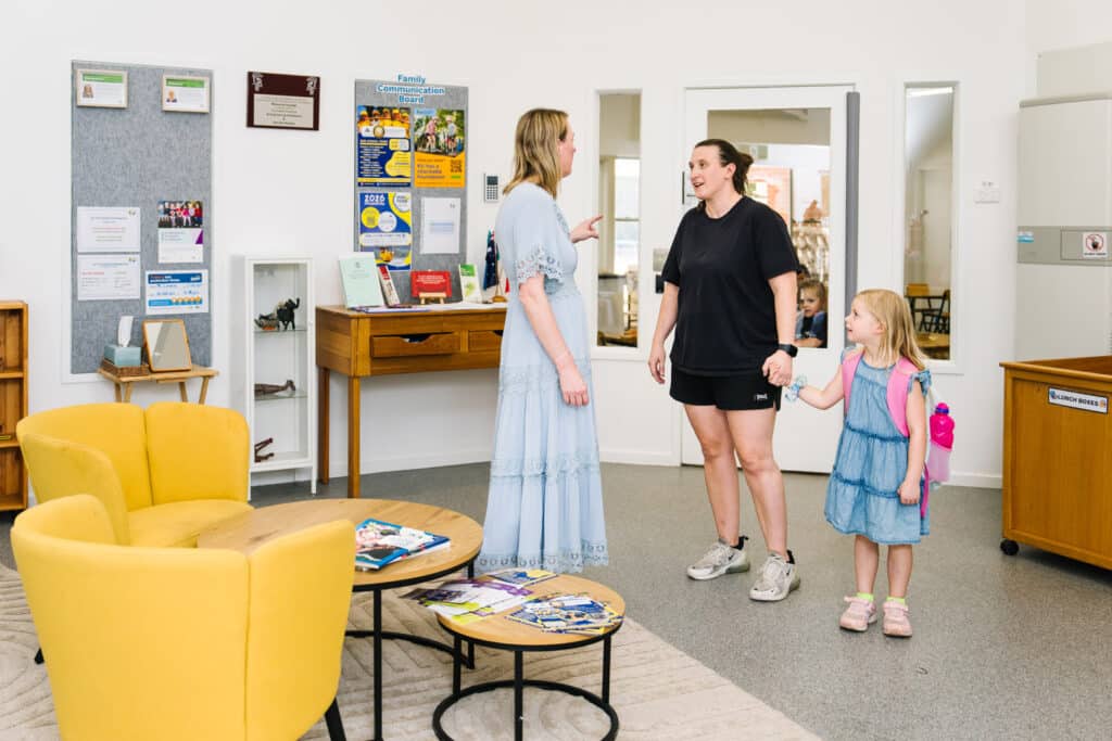 Educator talking with parent and child at KU The Fields childcare in Rowville