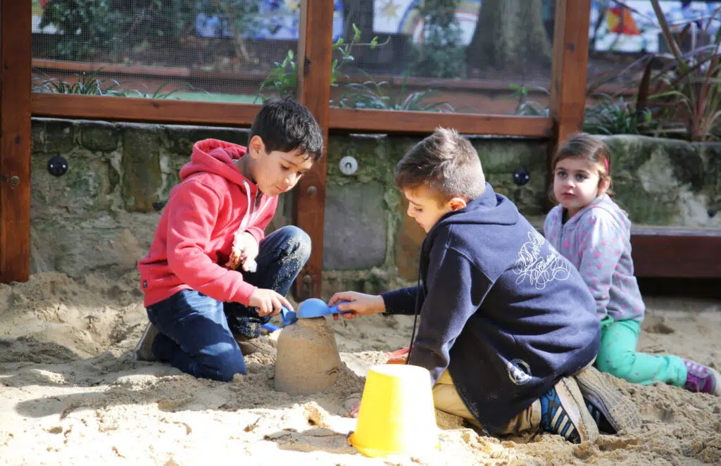 Children building sandcastles at KU John J. Carroll childcare