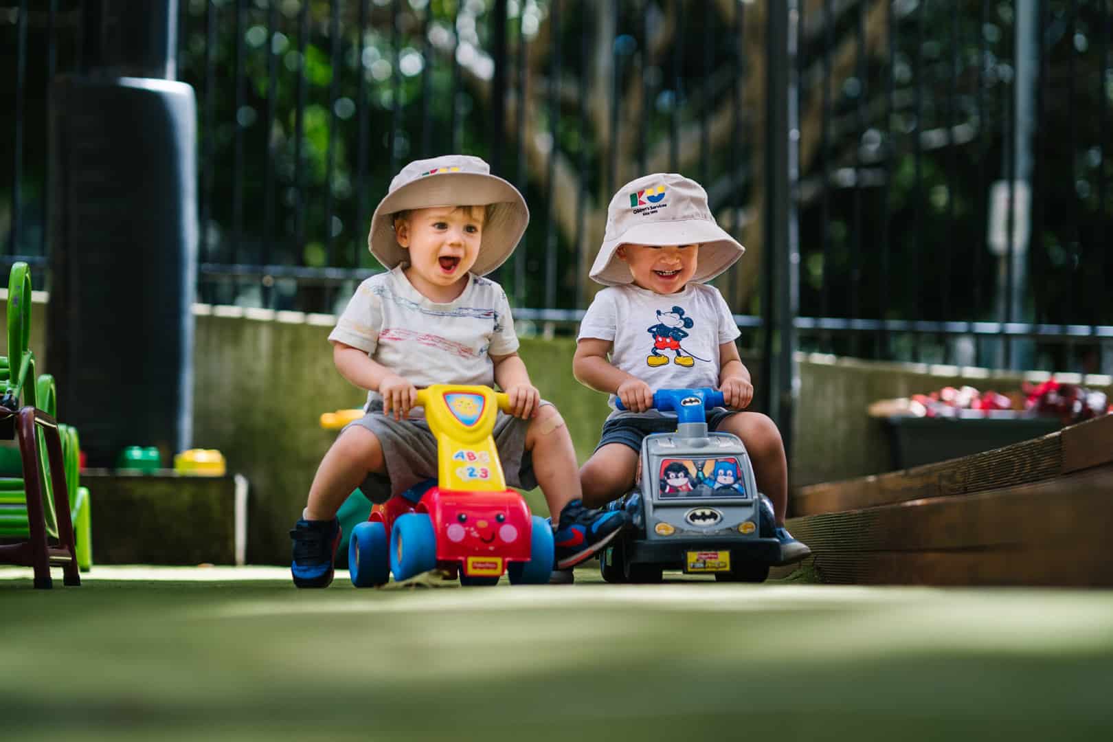 Children riding mini scooters at KU Phillip Park childcare