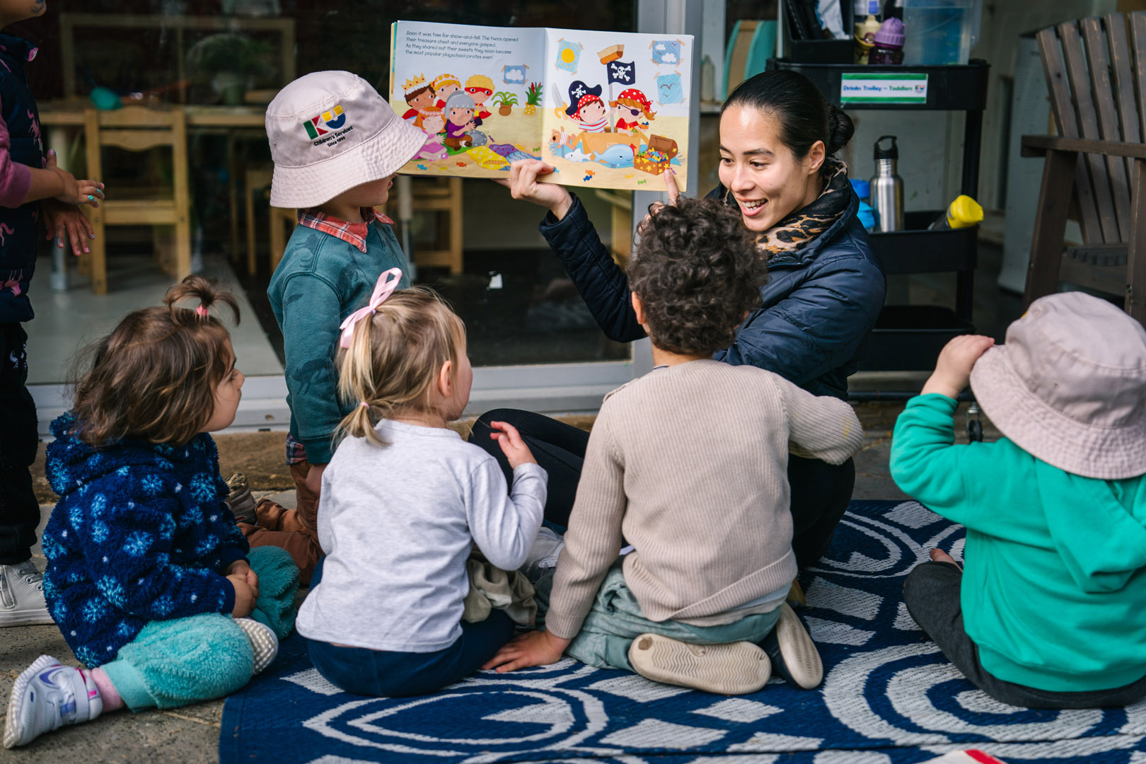 Educator reading to children at Sydney CBD childcare