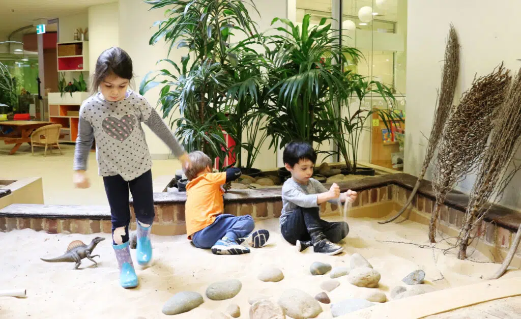 Children playing in the sand at KU's The Tree House childcare