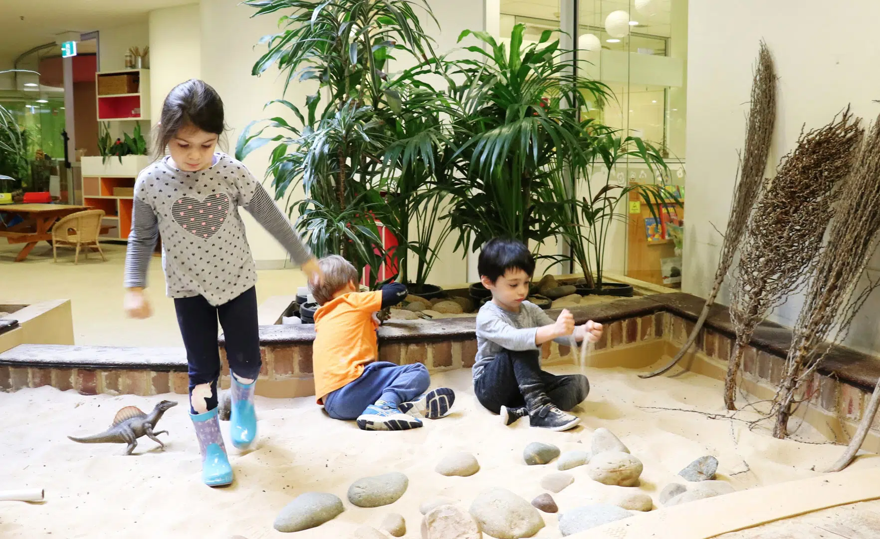 Children playing in the sand at KU's The Tree House childcare