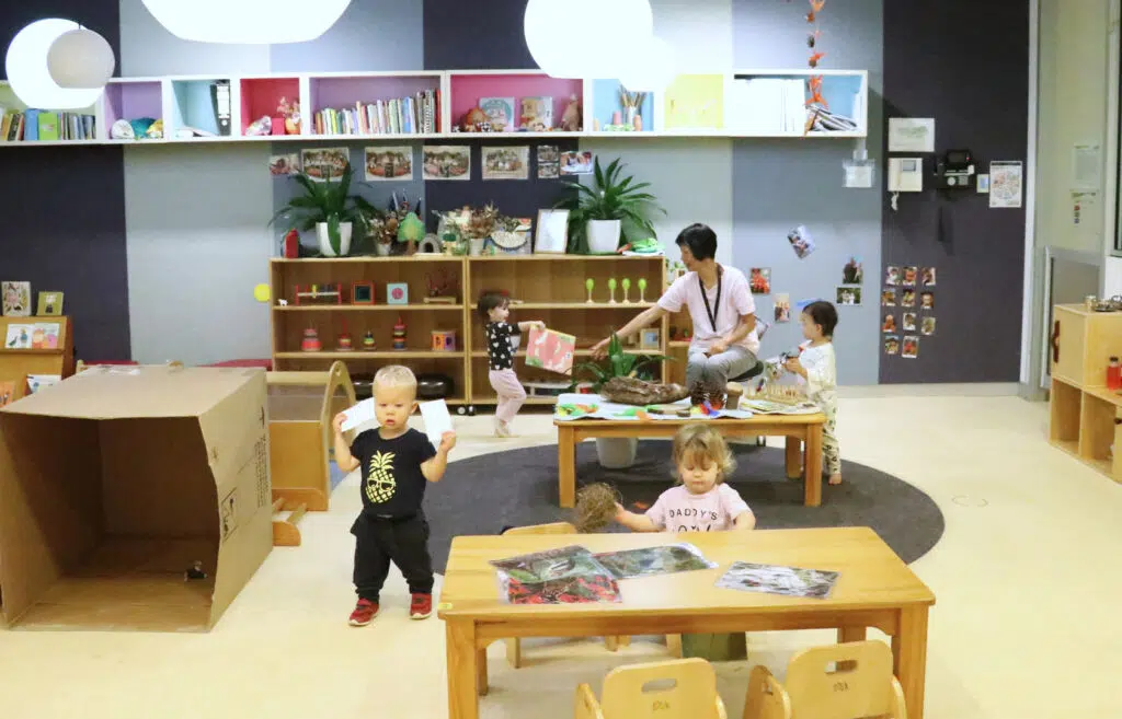 Children playing with educator at KU Treehouse childcare in Sydney CBD