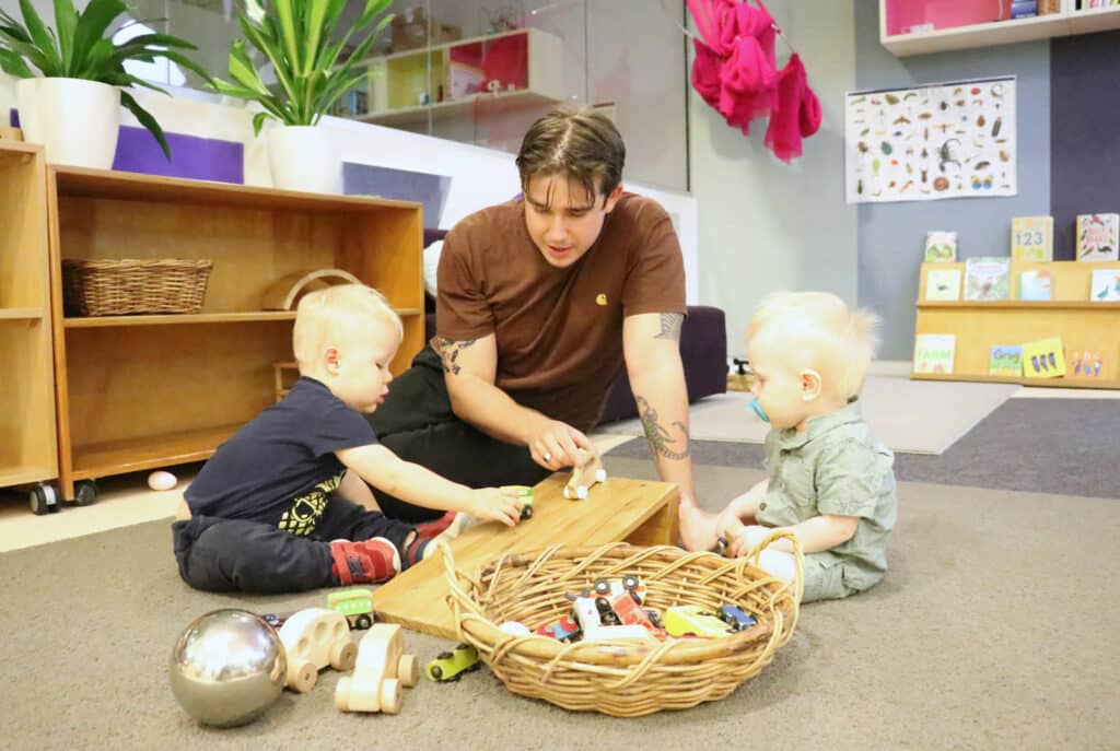 Children playing with educator at KU Treehouse childcare in Sydney CBD