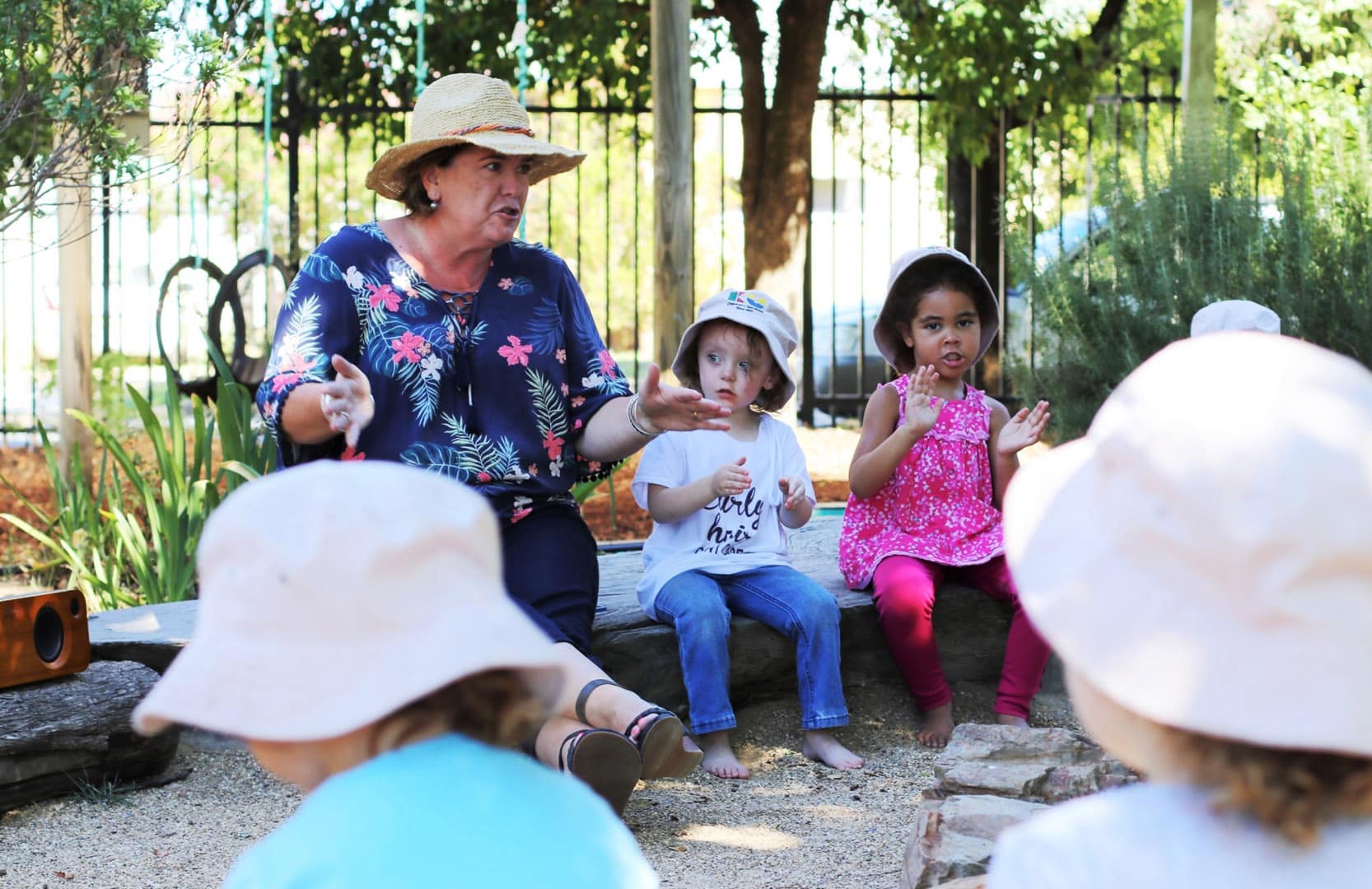 KU Kingfisher childcare educator and children singing a song