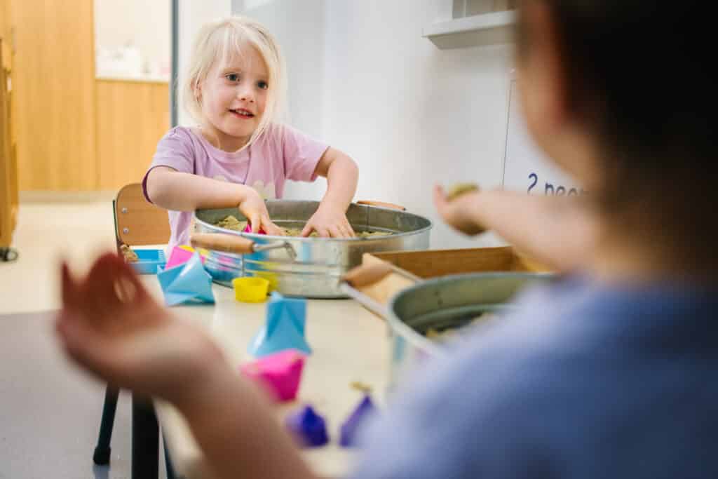Child playing at sensory table at KU Mariemont childcare in Wantirna