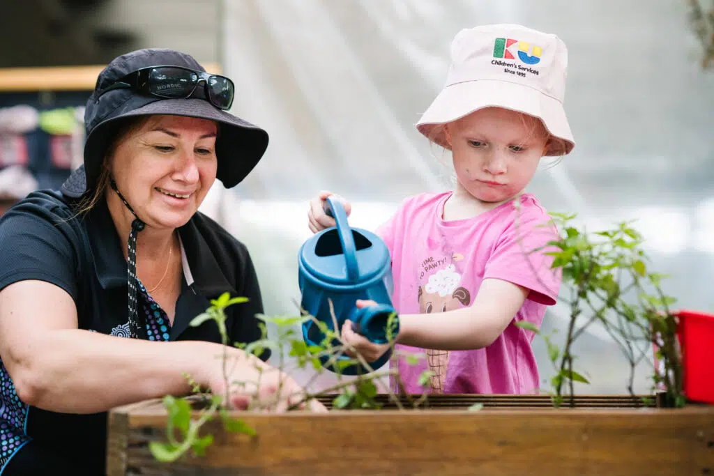 Educator gardening with child at KU Riddell Road Childcare in Wantirna South