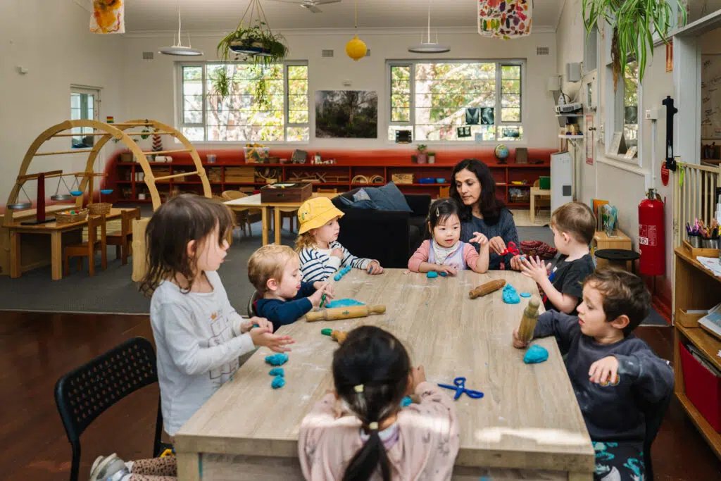 KU James Cahill childcare educator and children sculpting with playdough