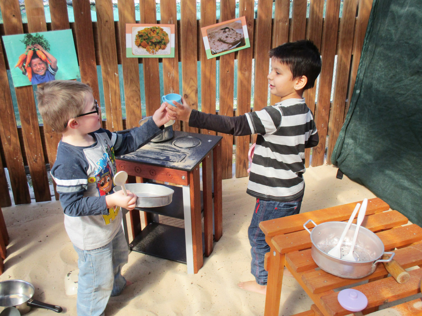 Children playing in an outdoor kitchen at KU Wentworthville childcare