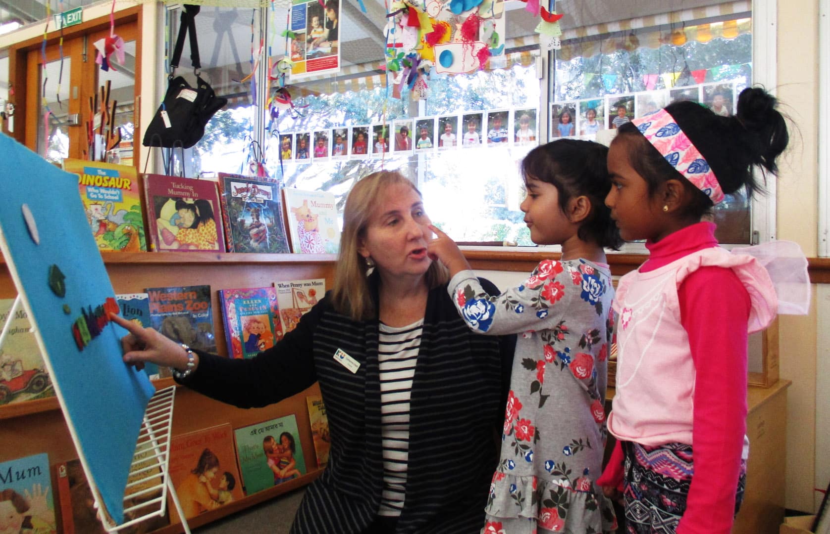 KU Wentworthville childcare educator playing fuzzy felts with children