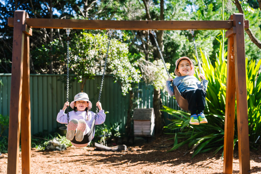 Children on swings at West Lindfield Childcare