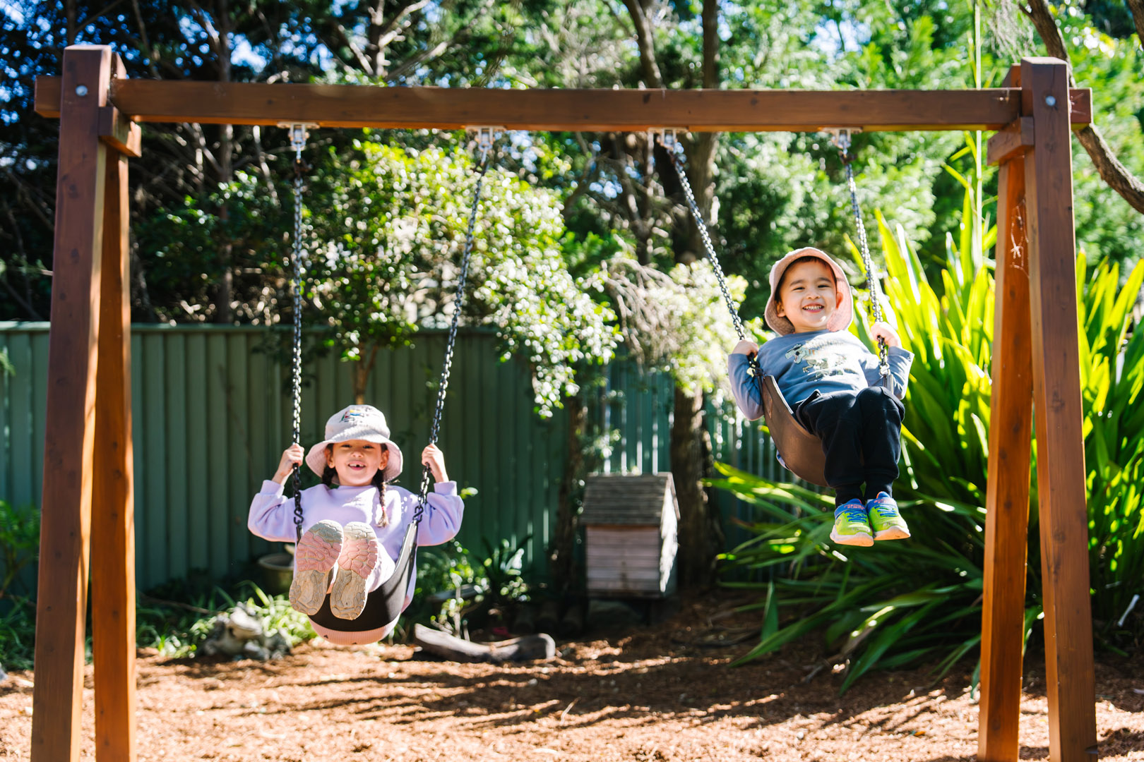 Children on swings at West Lindfield Childcare