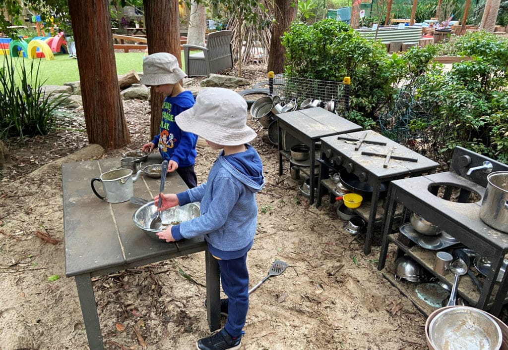 Children using the outdoor kitchen at KU West Pymble childcare
