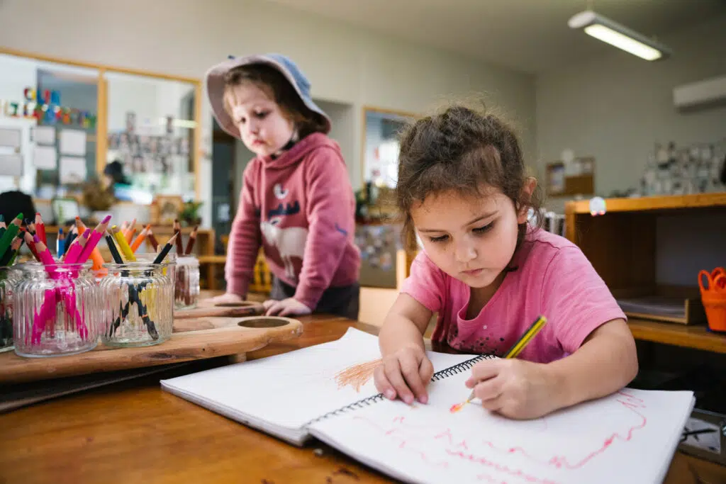 Children drawing pictures at KU Wickham childcare