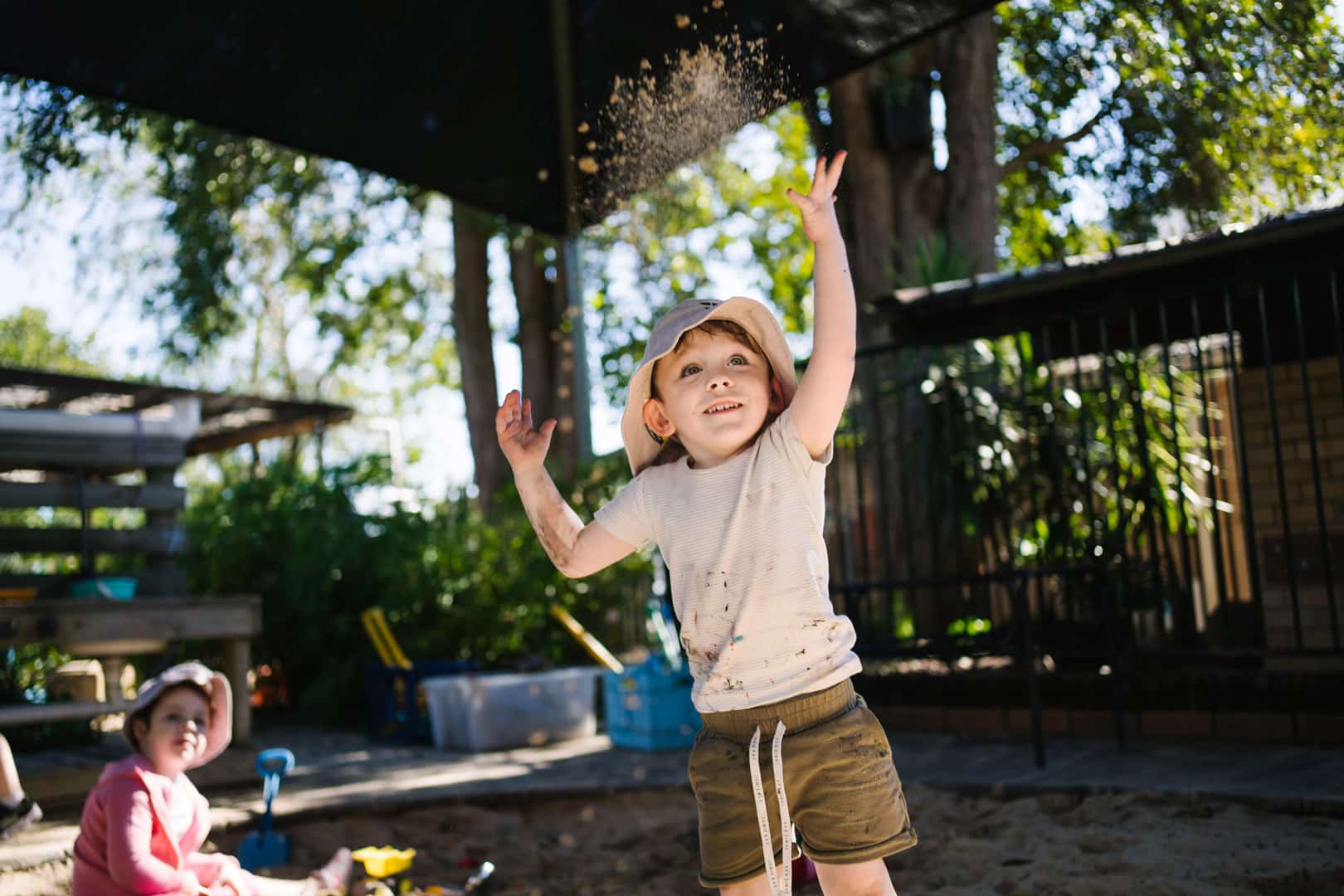Child playing in the sand at KU Windale childcare