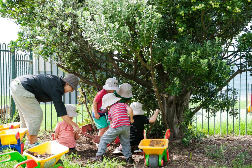 KU Wombarra childcare educator and children playing outside