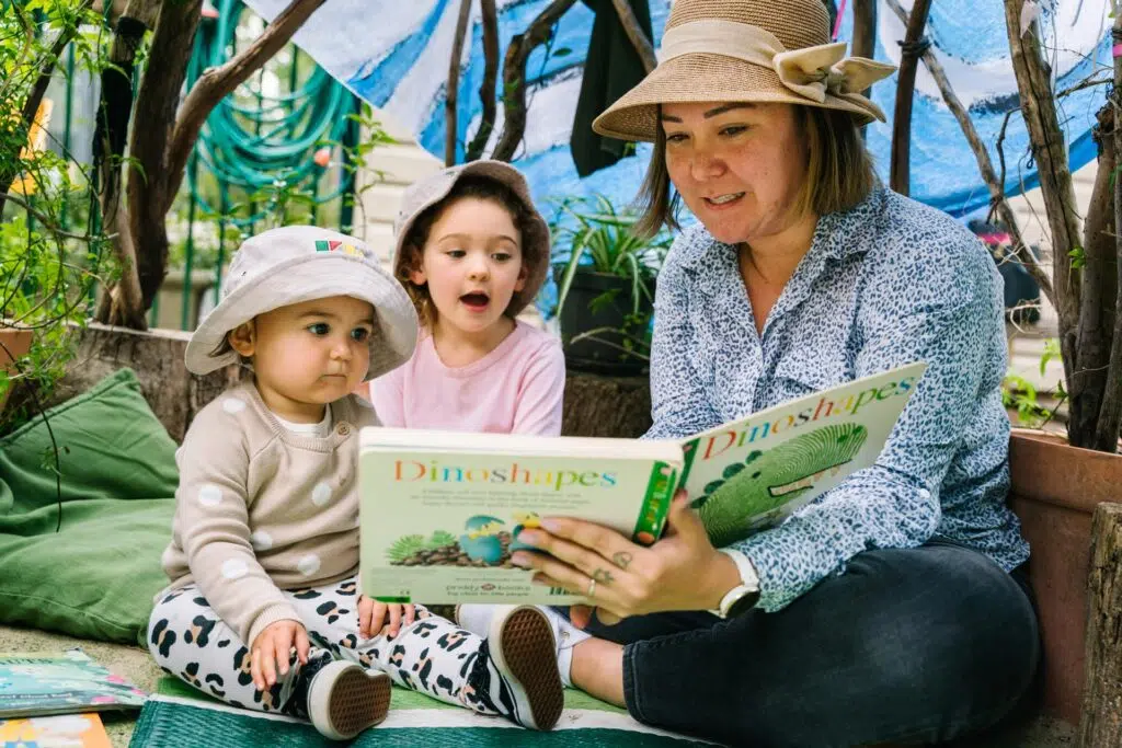 KU Carillon childcare educator reading to children