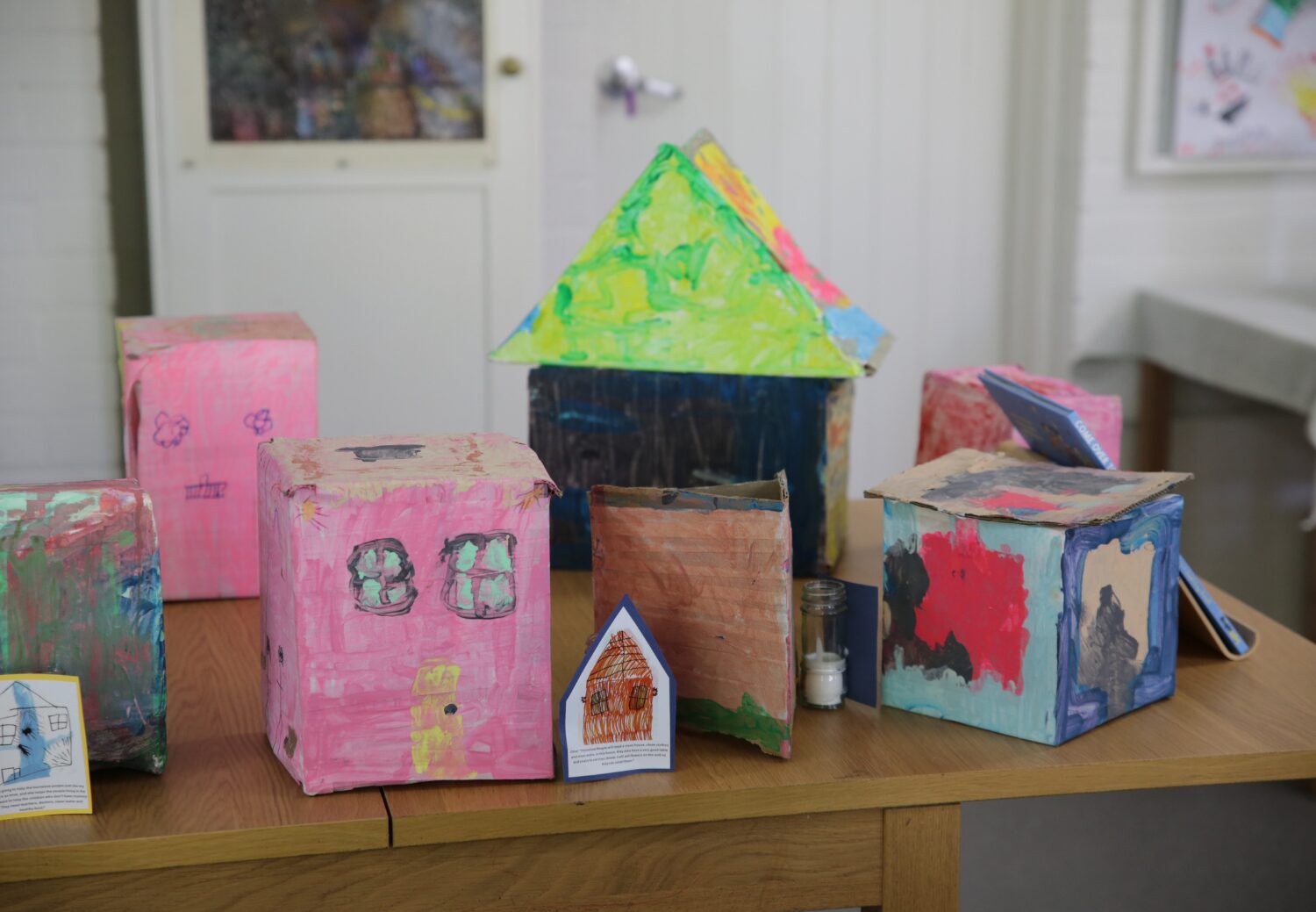 KU Sunbeam Preschool celebrates 100th anniversary 8 Historic display for KU Sunbeam Preschool's 100th Anniversary event. Children's art in the shape of small houses. Painted in various colours.