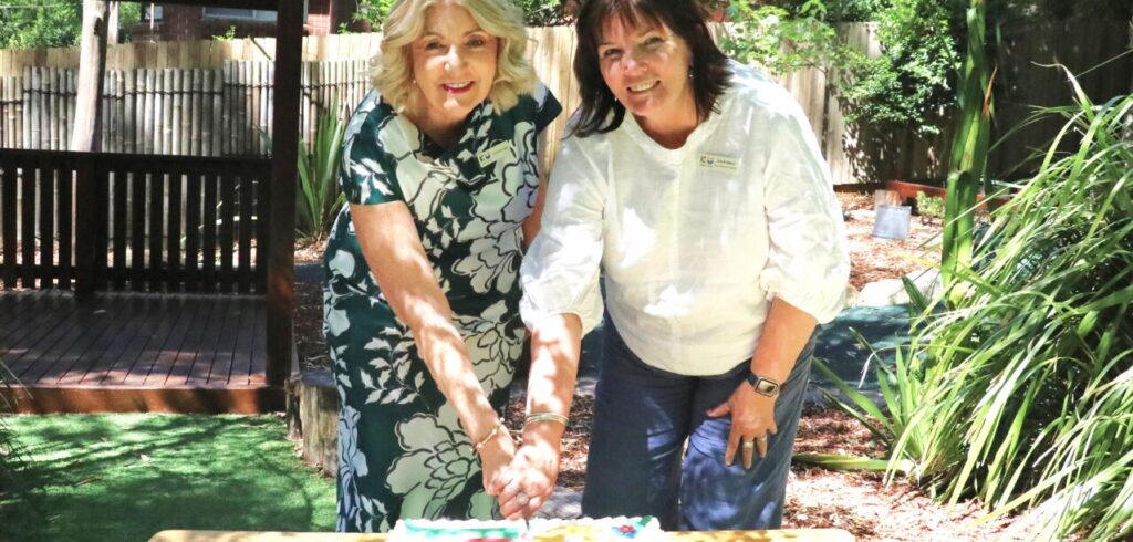 Chris Legg and ECT Julie cutting KU Chatswood West Preschool 70th Anniversary Cake